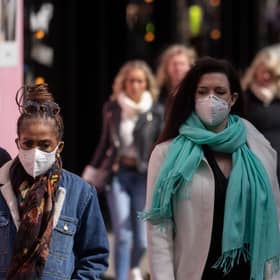 A woman wears a face mask while walking on Oxford Street durng the height of the coronavirus pandemic.
