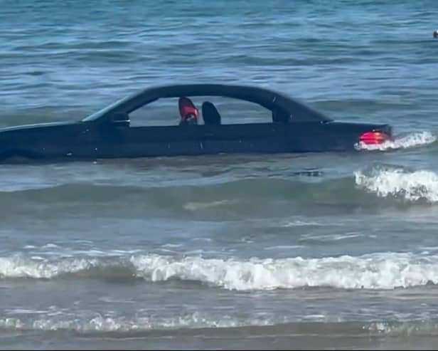 A convertable BMW was washed out to see after parking on a beach in Cornwall