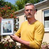 Leigh Blanning with a photo of his late father, John.