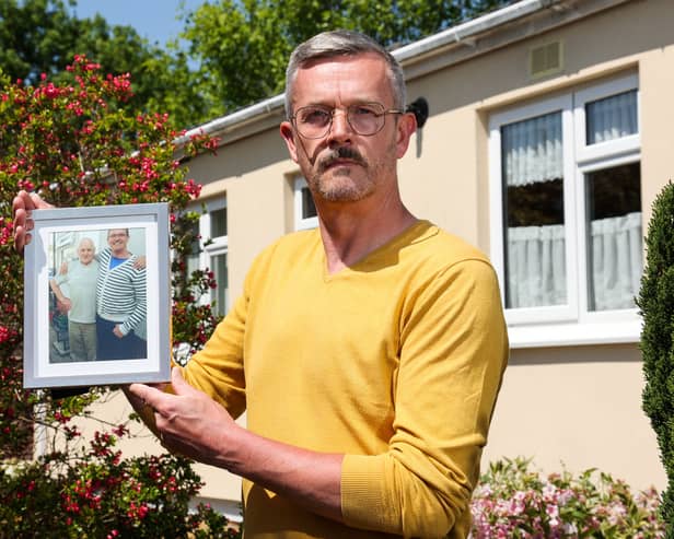 Leigh Blanning with a photo of his late father, John.