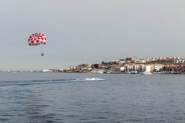 Tourists parasail in the Red Sea waters off of Egypt’s resort city of Hurghada on June 8, 2023, where a Russian national was mauled by a shark.
