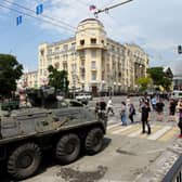 People walk past an armoured personnel carrier in the city of Rostov-on-Don, on June 24, 2023. Credit: Photo by STRINGER/AFP via Getty Images