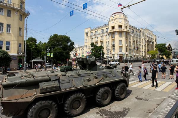 People walk past an armoured personnel carrier in the city of Rostov-on-Don, on June 24, 2023. Credit: Photo by STRINGER/AFP via Getty Images
