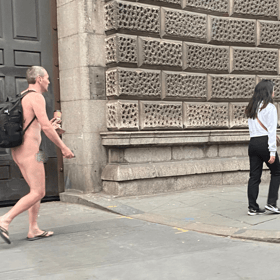 Kitted out in just a rucksack and flip flops while carrying a takeaway coffee, the commuter appeared to be grinning at fellow Londoners as he walked through the city naked.