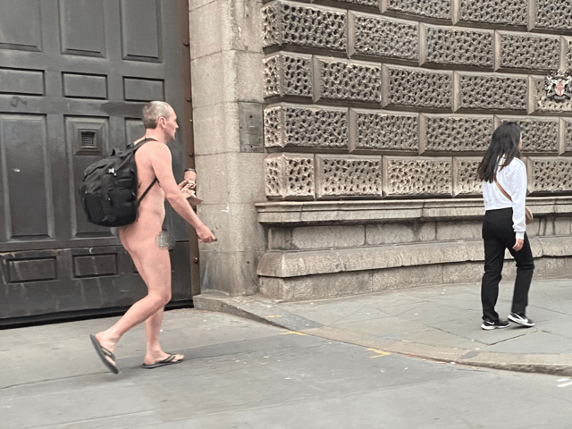 Kitted out in just a rucksack and flip flops while carrying a takeaway coffee, the commuter appeared to be grinning at fellow Londoners as he walked through the city naked.
