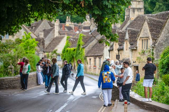 Tourists in Castle Combe, Wiltshire.