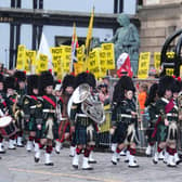 The Combined Cadet Force Pipes and Drums and the Cadet Military Band proceed down The Royal Mile.