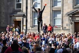 Street performers on the Royal Mile as part of the Edinburgh Festival Fringe - the largest of the festivals in terms of ticket sales, numbers of venues and numbers of participants.