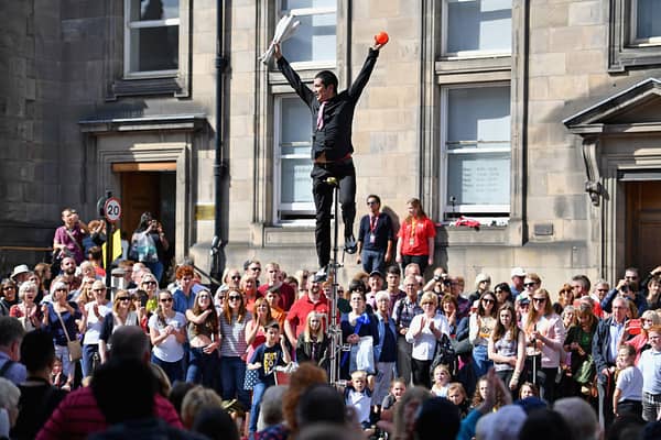 Street performers on the Royal Mile as part of the Edinburgh Festival Fringe - the largest of the festivals in terms of ticket sales, numbers of venues and numbers of participants.