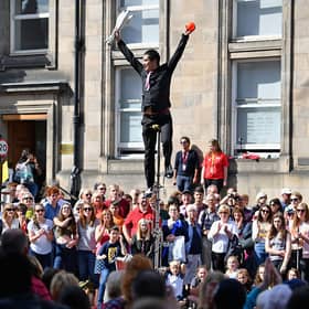 Street performers on the Royal Mile as part of the Edinburgh Festival Fringe - the largest of the festivals in terms of ticket sales, numbers of venues and numbers of participants.