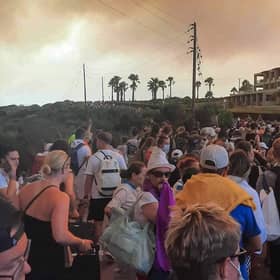 Tourists are evacuated from hotels during a wildfire on the Greek island of Rhodes on July 22, 2023.