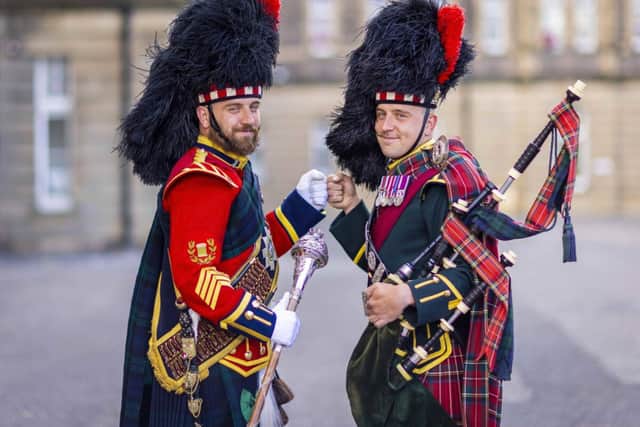 “Identical twins, Sergeants Peter and James Muir, led as the Scots pipe and drum majors at the Royal Edinburgh Military Tattoo.”