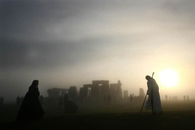 Arch Druid, Arthur Pendragon watches the sun rise at Stonehenge, Wiltshire, Wednesday December 21, 2005.