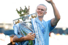 Erling Haaland and the Premier League trophy.