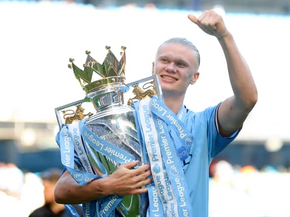Erling Haaland and the Premier League trophy.