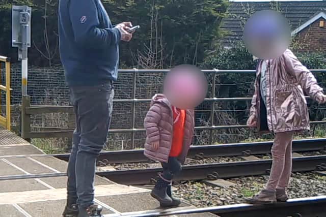 Shocking footage shows young children being played on the tracks