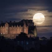 The full moon rises behind Edinburgh Castle. The July full moon, otherwise known as the Thunder Moon, is synonymous with summer storms.