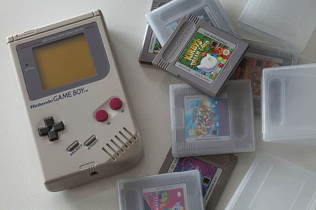 Super Mario Land (1989) cartridge next to the Nintendo Game Boy.