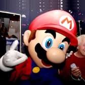 The voice of Super Mario, Charles Martinet, poses with Mario at GAME Oxford Street, central London, on the evening that Super Mario Galaxy on the Nintendo Wii goes on sale in the UK.