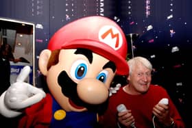 The voice of Super Mario, Charles Martinet, poses with Mario at GAME Oxford Street, central London, on the evening that Super Mario Galaxy on the Nintendo Wii goes on sale in the UK.