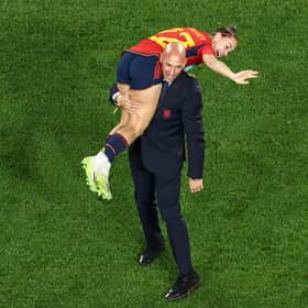 This picture taken on August 20, 2023 shows President of the Royal Spanish Football Federation Luis Rubiales carrying Spain's Athenea del Castillo Beivide on his shoulder as they celebrate winning the Australia and New Zealand 2023 Women's World Cup final football match between Spain and England at Stadium Australia in Sydney. 