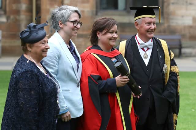 Comedian and broadcaster Susan Calman, (second right) her wife Lee Cormack (second left) and father Kenneth Calman (right) holding her honorary degree in the East Quadrangle at Glasgow University after receiving it in a ceremony.