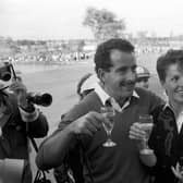 “Europe's Sam Torrance toasts victory with his wife Elizabeth after holing the winning putt.” (1985) 
