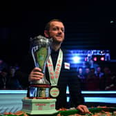 Northern Ireland's Mark Allen poses with the winner's trophy after the snooker final of the 2022 Cazoo UK Championship at the York Barbican in York.