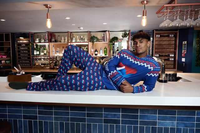 While we can't recommend copying this model and sprawling across a Travelodge bar, here's how you can grab your own set of festive pyjamas. Image: Travelodge