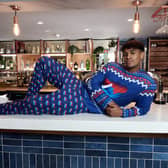 While we can't recommend copying this model and sprawling across a Travelodge bar, here's how you can grab your own set of festive pyjamas. Image: Travelodge