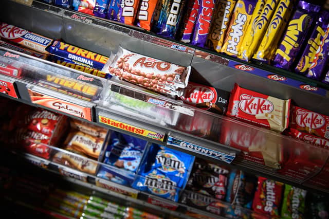 A selection of confectionary and chocolates on a newsagent shelf