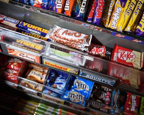 A selection of confectionary and chocolates on a newsagent shelf
