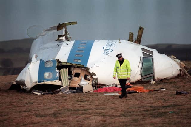 A Policeman walks away from the cockpit of the 747 Pan Am airliner that exploded and crashed over Lockerbie, Scotland, 21 December 1988. 