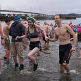 Swimmers brave the waters of South Queensferry for an unofficial 'Loony Dook' on New Year's Day 2023.