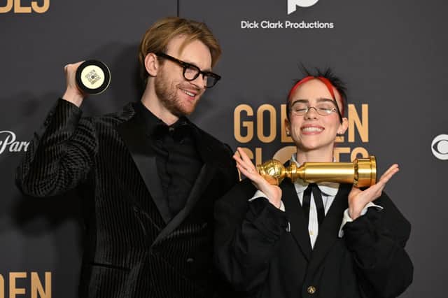 Musicians Billie Eilish and Finneas O'Connell pose with the award for Best Original Song - Motion Picture