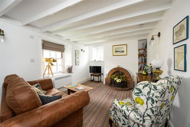 The pretty sitting room features a beamed ceiling