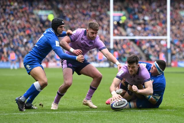 Scotland's Blair Kinghorn of Scotland dives over to score the third Scotland try during the Six Nations Rugby match between Scotland and Italy at Murrayfield Stadium on March 18, 2023.