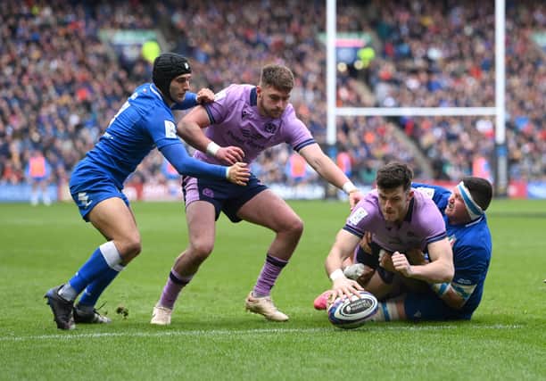 Scotland's Blair Kinghorn of Scotland dives over to score the third Scotland try during the Six Nations Rugby match between Scotland and Italy at Murrayfield Stadium on March 18, 2023.