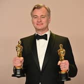  British director Christopher Nolan poses in the press room with the Oscars for Best Director and Best Picture for "Oppenheimer" during the 96th Annual Academy Awards at the Dolby Theatre in Hollywood, California on March 10, 2024. (Photo by Robyn BECK / AFP)