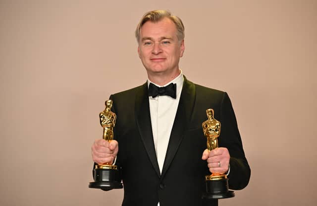 British director Christopher Nolan poses in the press room with the Oscars for Best Director and Best Picture for "Oppenheimer" during the 96th Annual Academy Awards at the Dolby Theatre in Hollywood, California on March 10, 2024. (Photo by Robyn BECK / AFP)