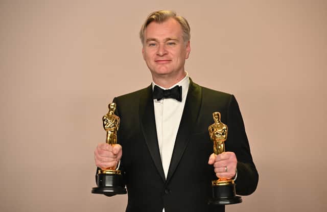  British director Christopher Nolan poses in the press room with the Oscars for Best Director and Best Picture for "Oppenheimer" during the 96th Annual Academy Awards at the Dolby Theatre in Hollywood, California on March 10, 2024. (Photo by Robyn BECK / AFP)