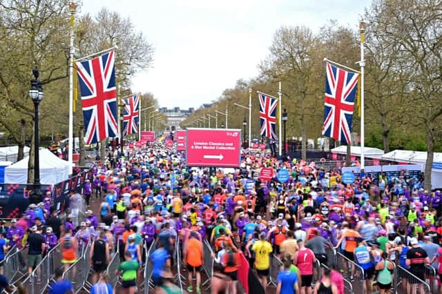 Runners reach the finish of the 2023 London Marathon.