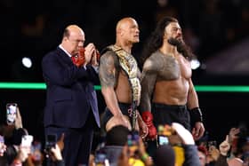 Paul Heyman, Dwayne "The Rock" Johnson and Roman Reigns look on following a fight against Cody Rhodes and Seth "Freakin" Rollins during Night One of WrestleMania 40. (Photo by Tim Nwachukwu/Getty Images)