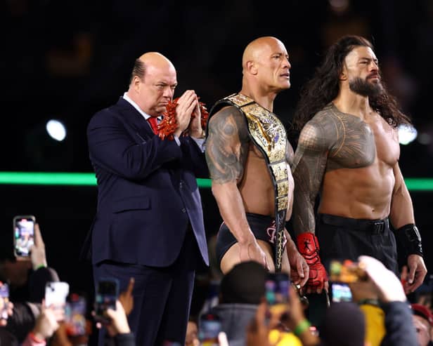 Paul Heyman, Dwayne "The Rock" Johnson and Roman Reigns look on following a fight against Cody Rhodes and Seth "Freakin" Rollins during Night One of WrestleMania 40. (Photo by Tim Nwachukwu/Getty Images)