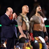 Paul Heyman, Dwayne "The Rock" Johnson and Roman Reigns look on following a fight against Cody Rhodes and Seth "Freakin" Rollins during Night One of WrestleMania 40. (Photo by Tim Nwachukwu/Getty Images)