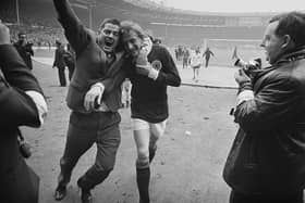 Scottish football player Denis Law is hugged by a fan after Scotland beat England 3-2 at Wembley. Cr. Getty Images.