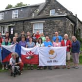 Simon Neal and his partner Maureen on the far right with a group of visitors at the hostel 