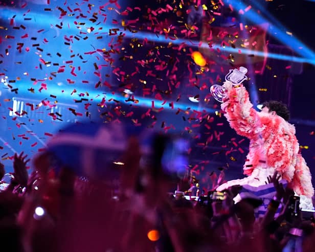 MALMO, SWEDEN - MAY 11: Nemo from Switzerland, winner of the Eurovision Song Contest, raises the trophy on stage after The Eurovision Song Contest 2024 Grand Final at Malmo Arena on May 11, 2024 in Malmo, Sweden. (Photo by Martin Sylvest Andersen/Getty Images)