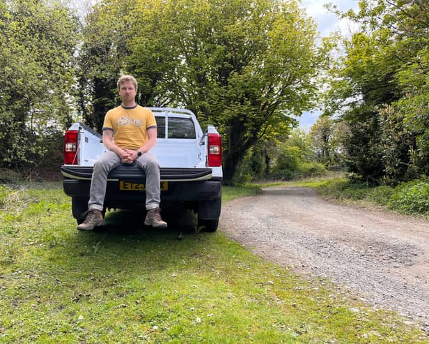 Scotsman writer Steven Chisholm sits in the back of the Ford Ranger XL test car near a section of gravel track. Credit: Steven Chisholm
