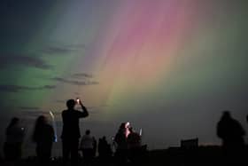 People visit St Mary's lighthouse in Whitley Bay to see the aurora borealis on 10 May 2024 (Photo: Ian Forsyth/Getty Images)